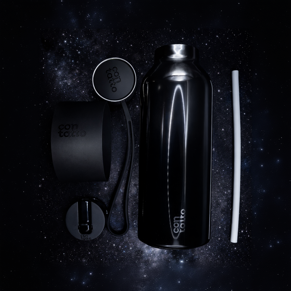 Black water bottle set with accessories on a starry background