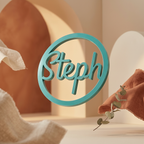 Teal decorative round love charm with 'Steph' on a neutral background