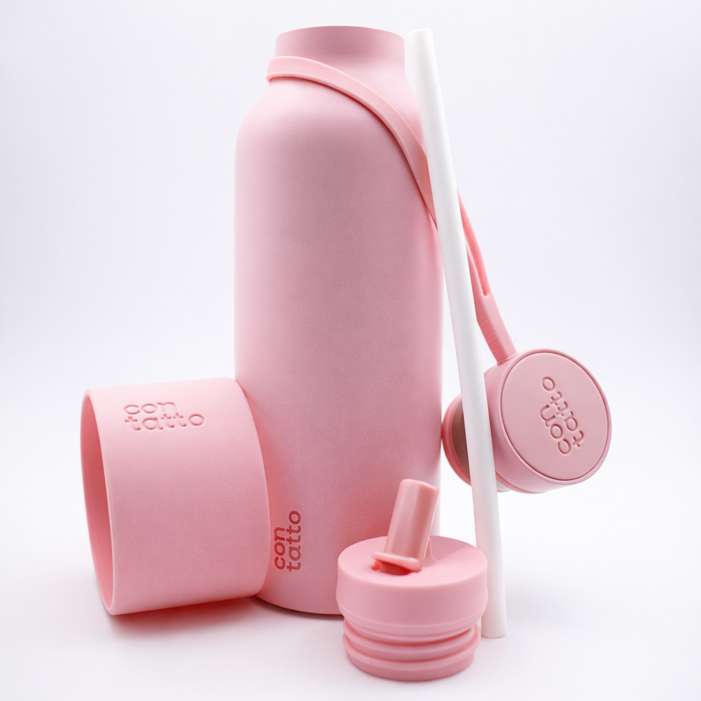 Pink silicone water bottle set with multiple components on a white background