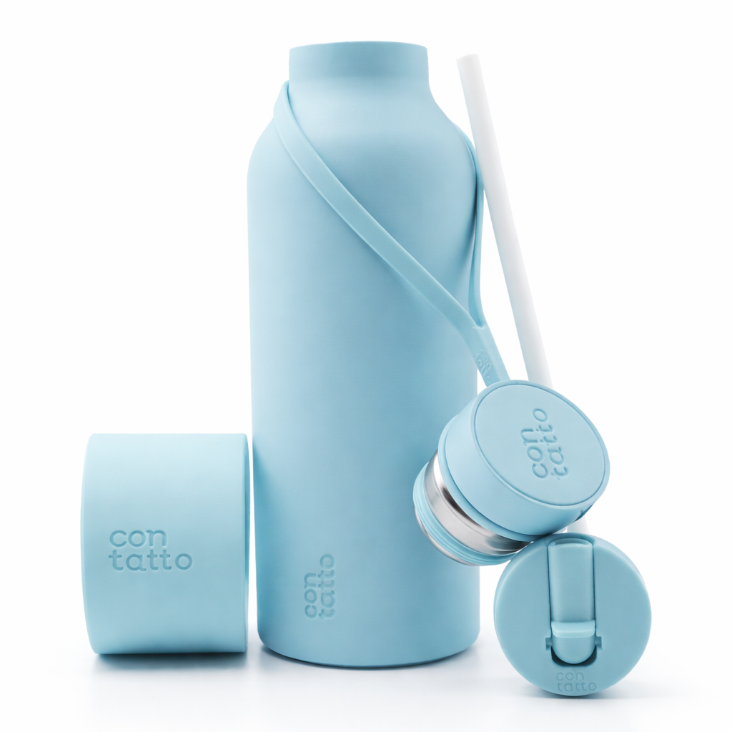 Light blue silicone water bottle with multiple components on a white background