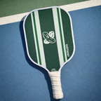 Green and white striped pickleball paddle on a blue and green court