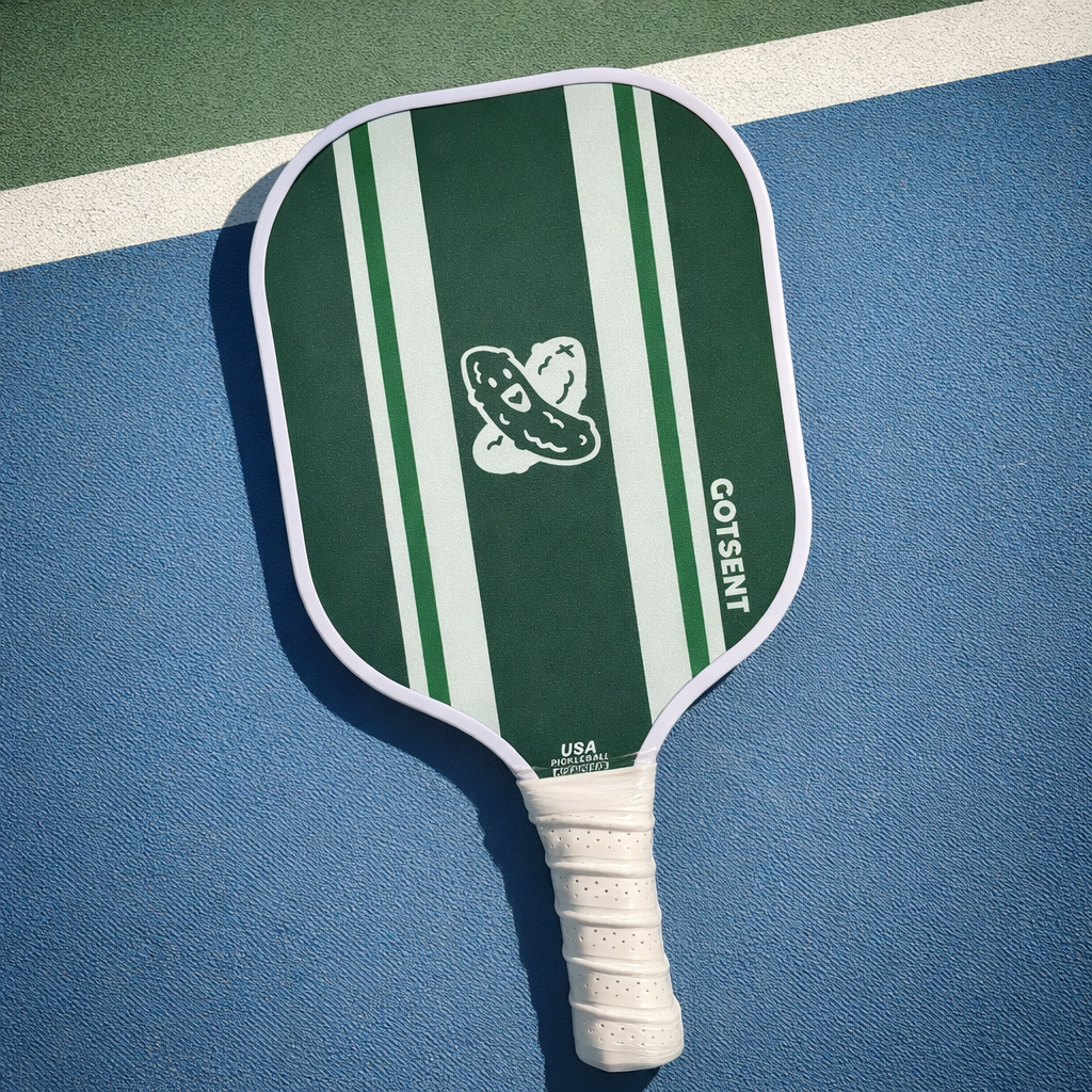 Green and white striped pickleball paddle on a blue and green court