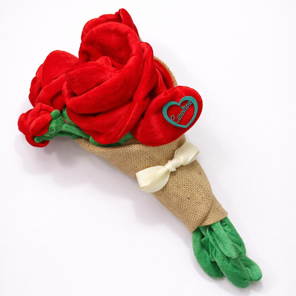 Red rose plush bouquet with green leaves and a beige ribbon on a white background