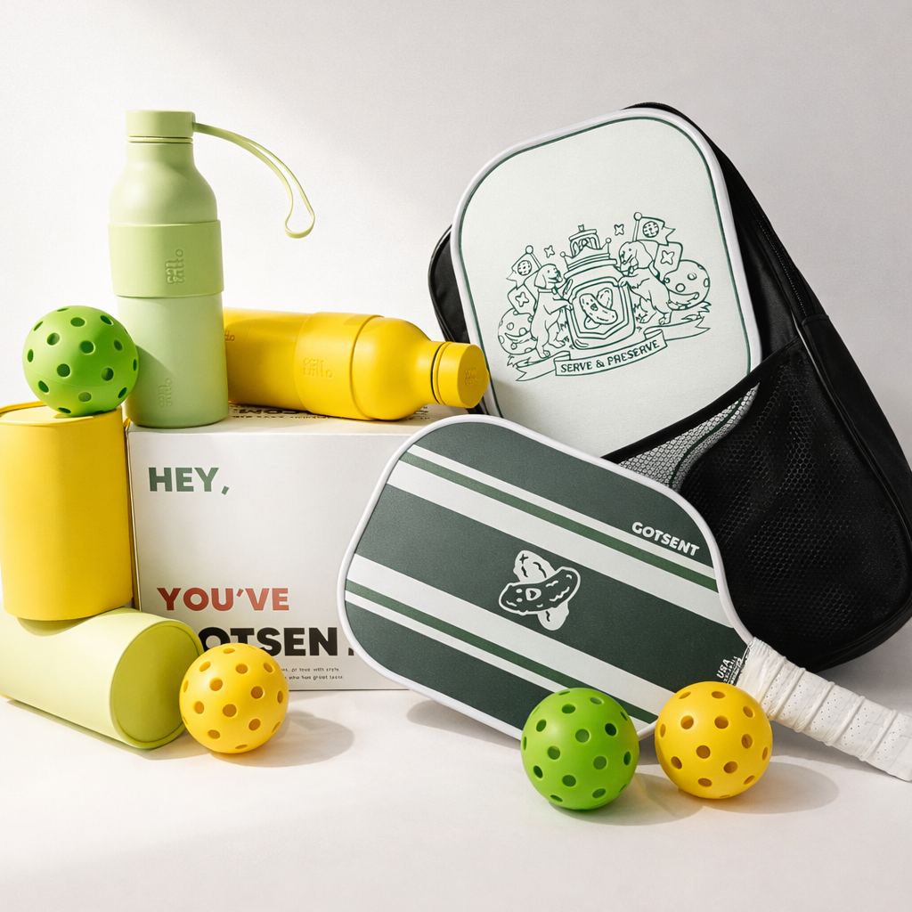 Pickleball paddles, balls, and bottles on a light gray background