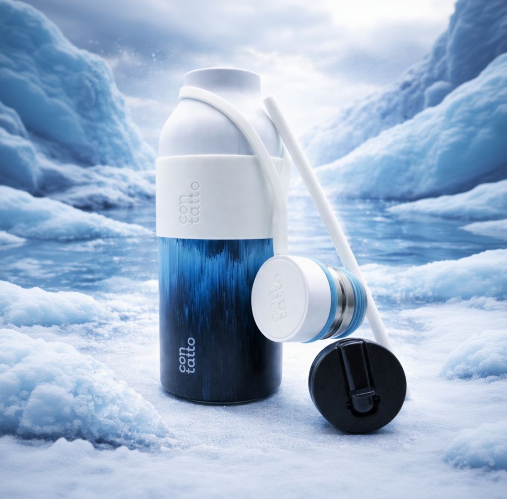 Blue and white water bottle with carrying strap on a snowy landscape