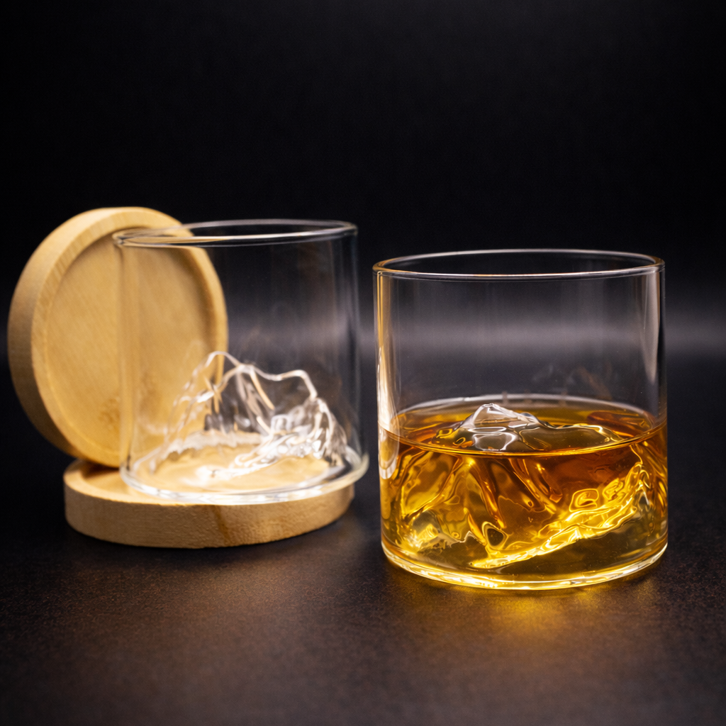 Glass of whiskey with a wooden coaster on a dark surface